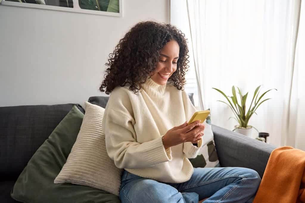 Woman smiles while texting