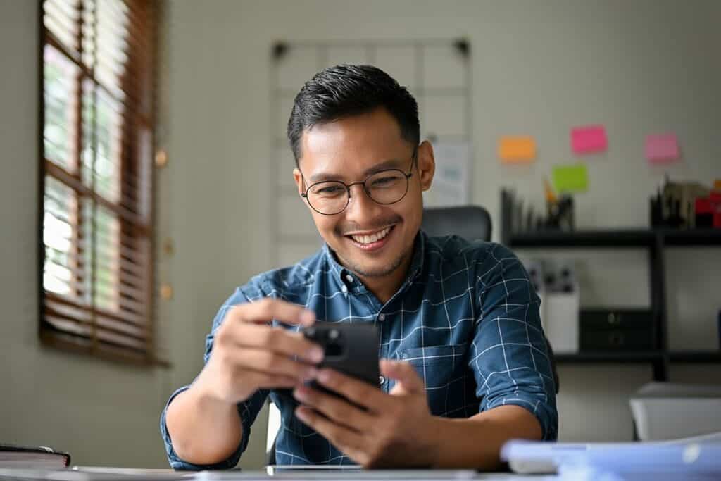 Man smiles while talking to friend about his positive partial hospitalization program experience