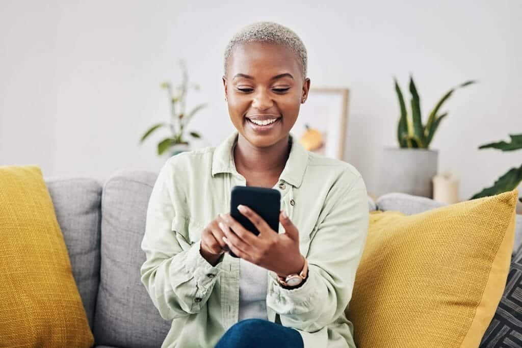 Woman looks up residential addiction treatment on her cell phone