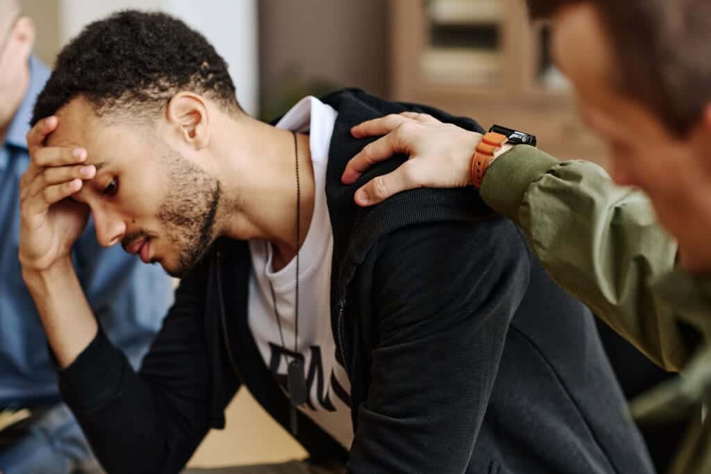 man with head in hands learning heroin facts