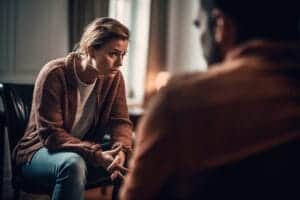 Woman listens intently during a substance abuse treatment program