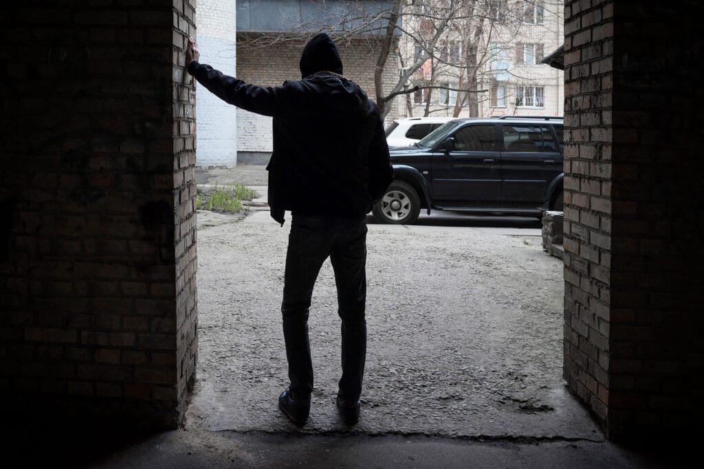 person leans against wall and considers the long term effects of cocaine